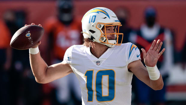 Los Angeles Chargers quarterback Justin Herbert (10) looks to pass in the first quarter against the Denver Broncos at Empower Field at Mile High.